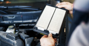 Pearson Auto employee checks a car filter