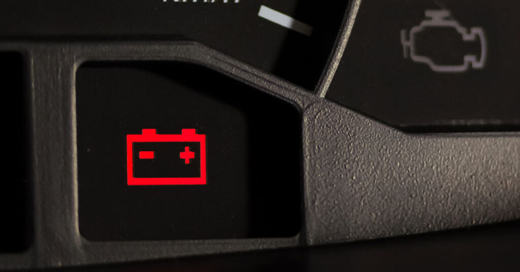 Close-up of the battery maintenance light on an auto dashboard.