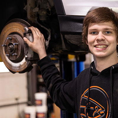Pearson Auto employee changes brake pads