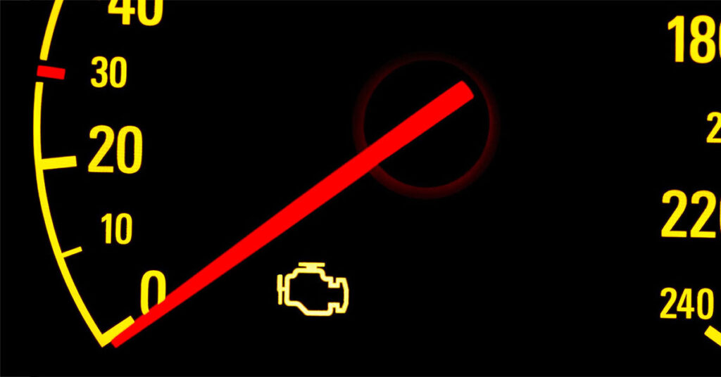 speedometer with yellow numbers; the check engine light is on