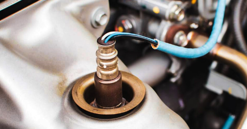 Close-up shot of a car's oxygen sensor.